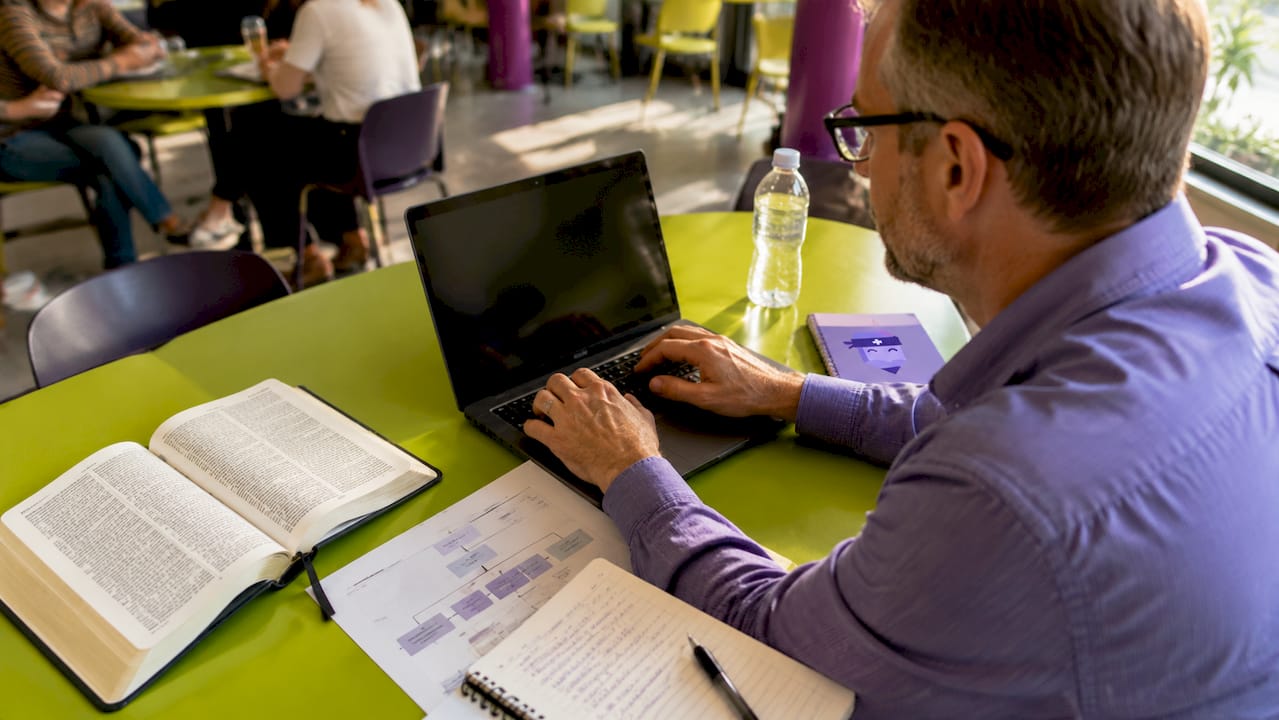 Church staff coordinating workflow at desk