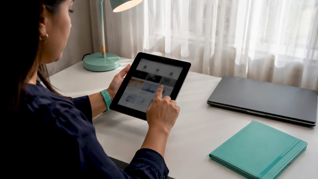 Hands scrolling HR time management tools on tablet