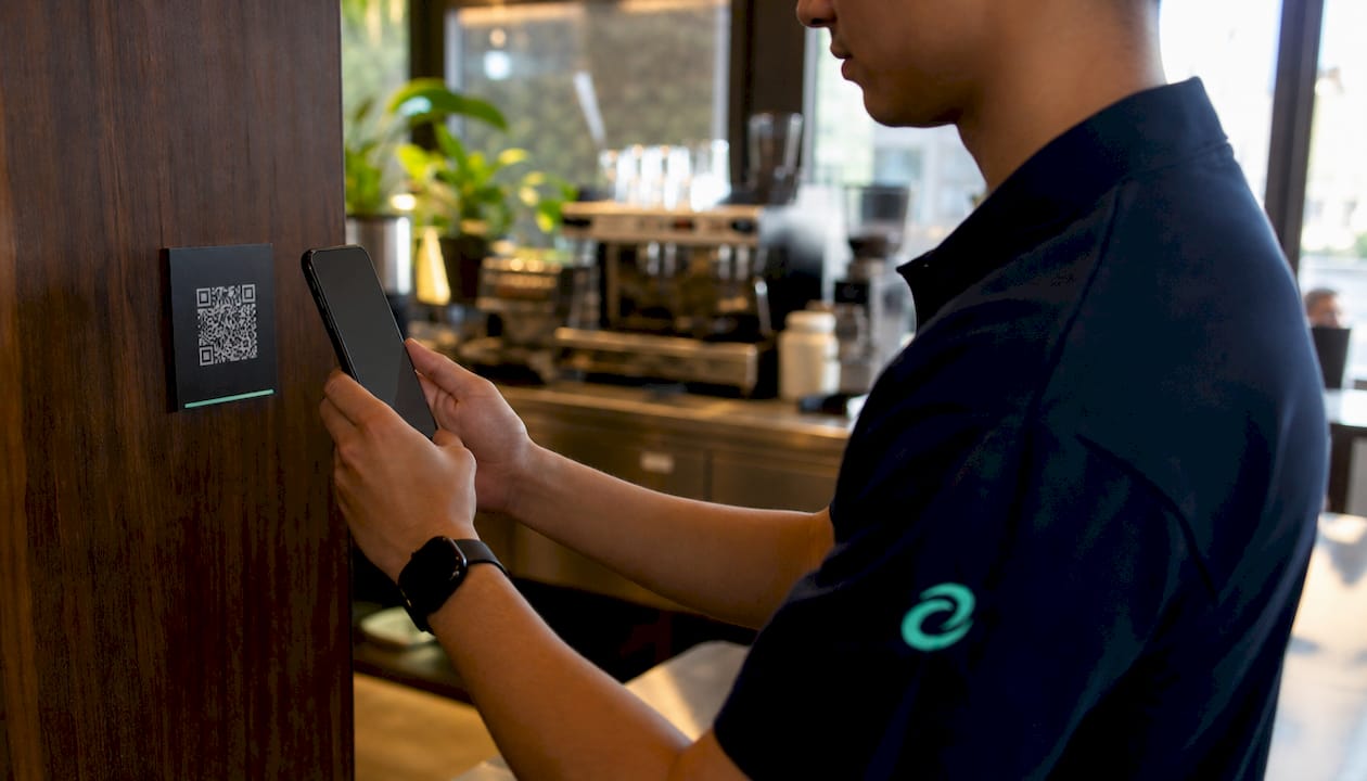 Retail employee scanning QR code for clock-in