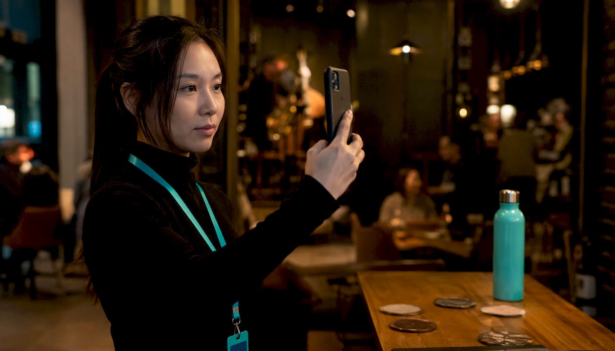 Female technician taking biometric verification selfie