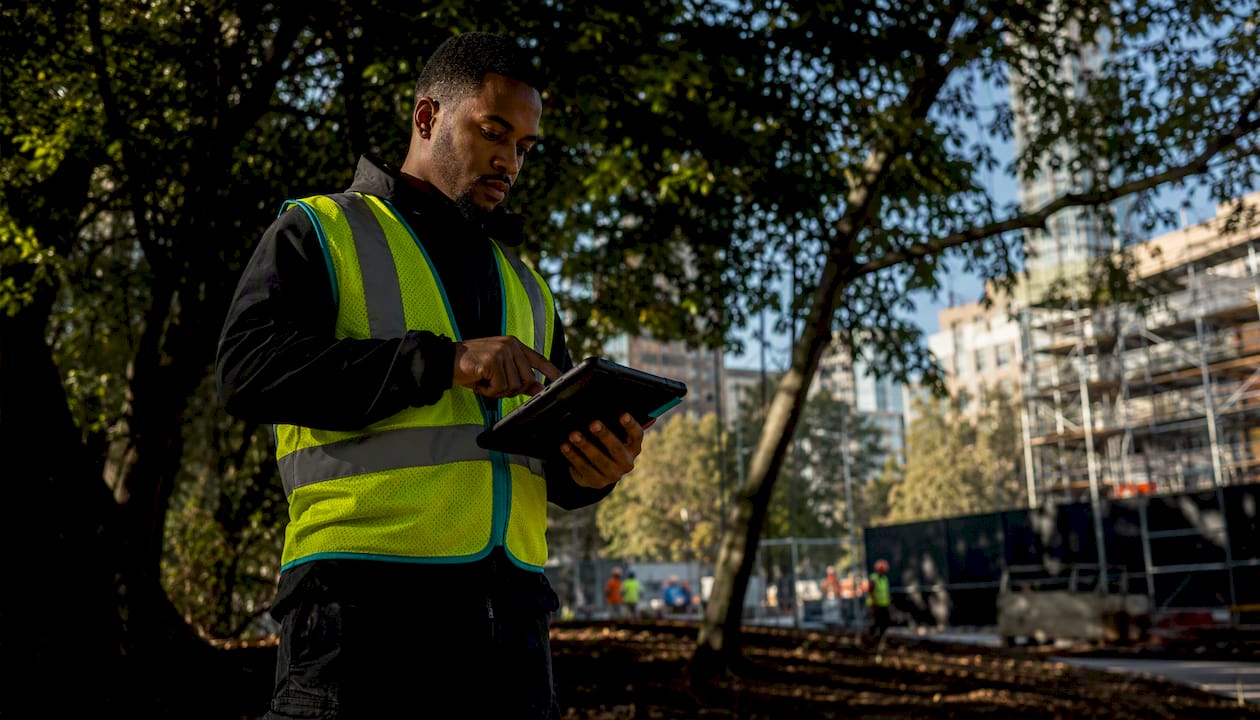Field supervisor using tablet for time tracking outdoors