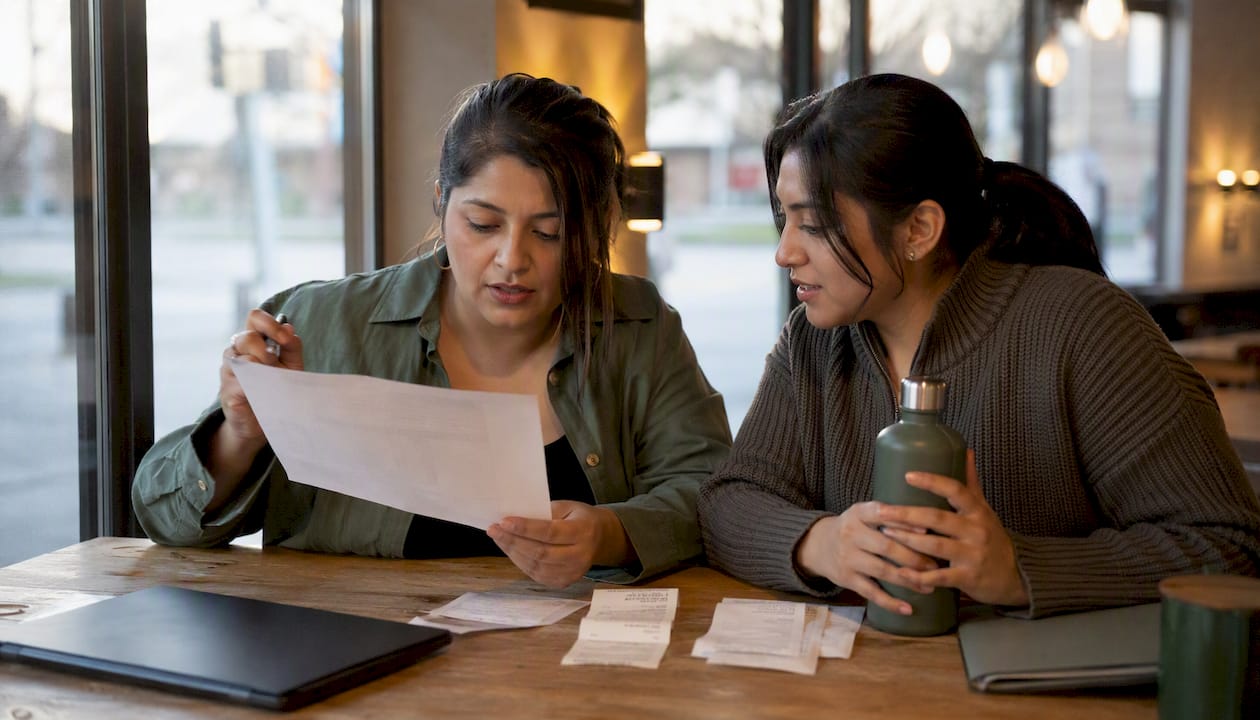 Two amazon sellers analyzing shipment invoices together