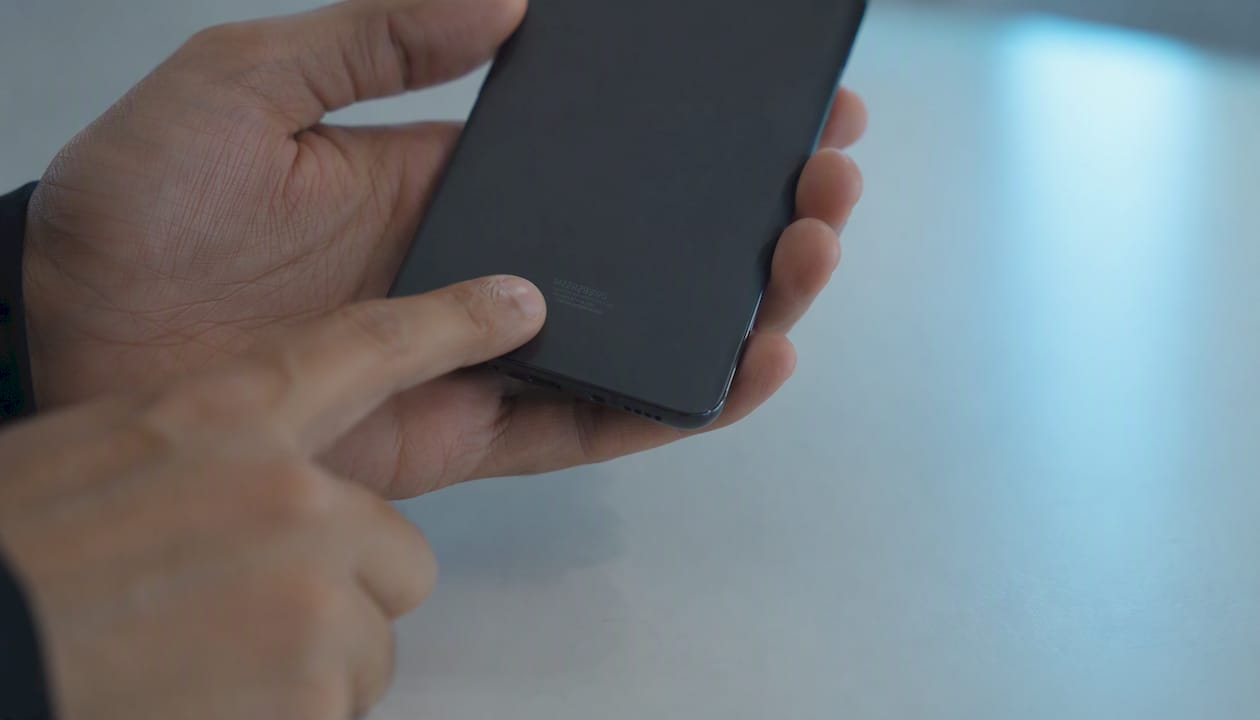 Hands pointing at phone model number detail