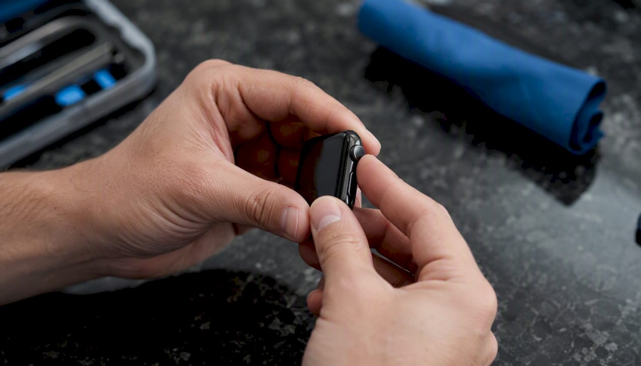 Hands checking smartwatch buttons close-up