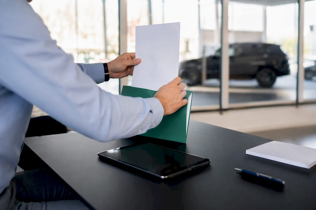 Dealer hands attaching transport invoice photo