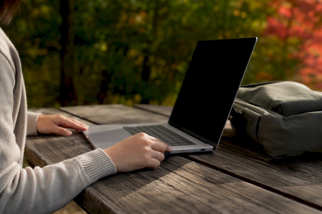 Hands checking battery health indicator on laptop