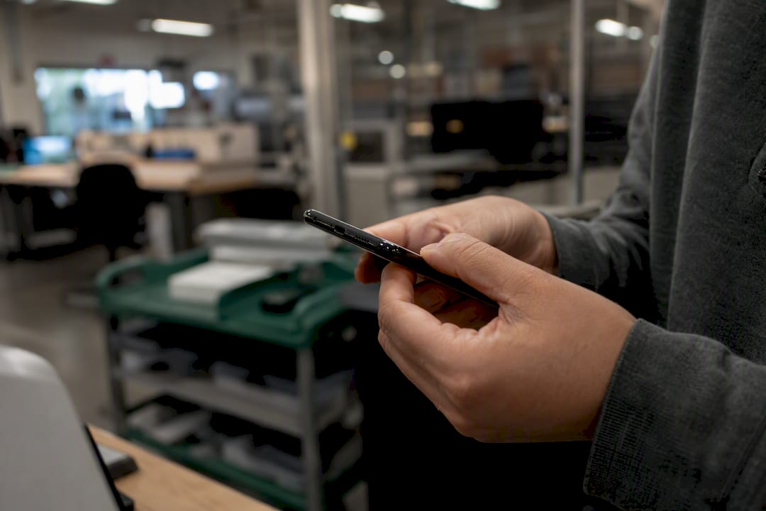 Hands inspecting phone edge during device inspection