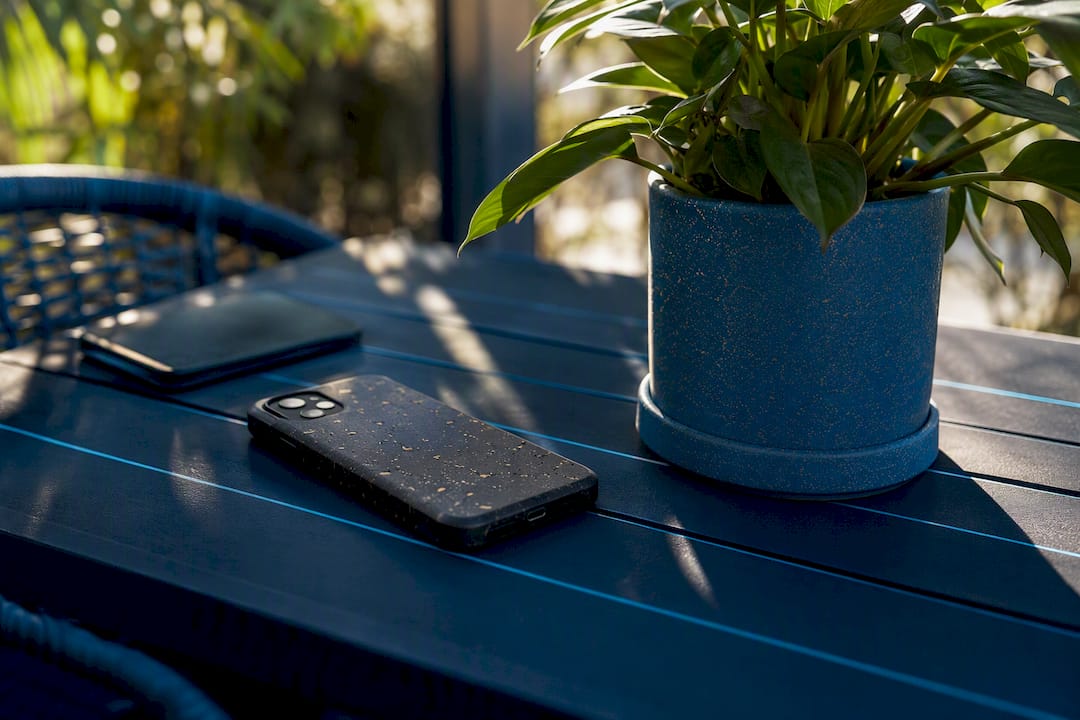 Eco-friendly tech workspace with blurred smartphone