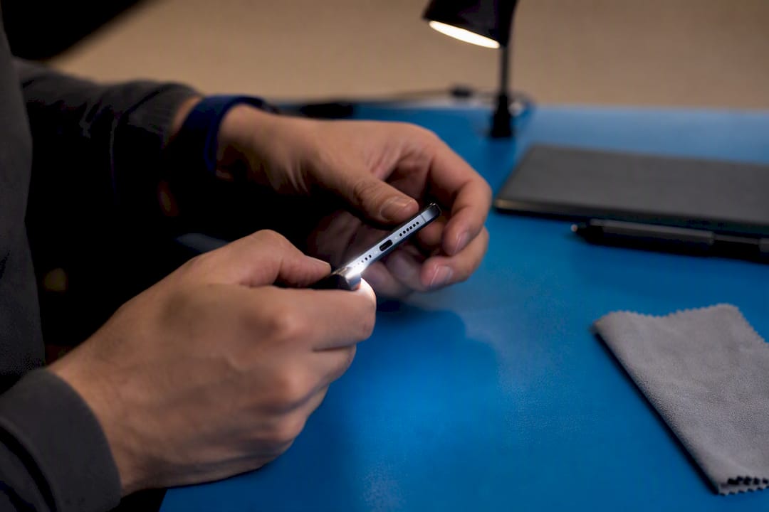 Hands testing phone buttons and ports