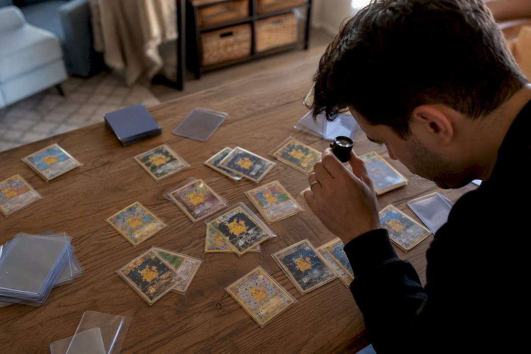 Hands sorting vintage Pikachu cards
