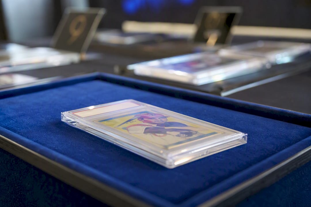 Graded card slab on auction display tray