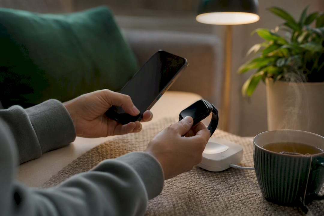 Hands unpairing a smartwatch using a phone