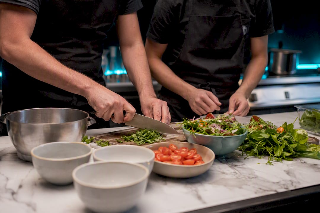 Hands garnishing food during buddy training