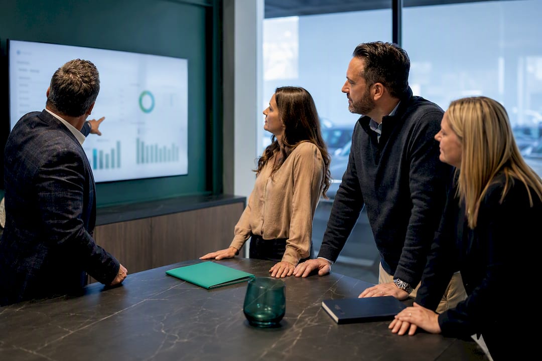 Dealership managers reviewing KPI dashboard