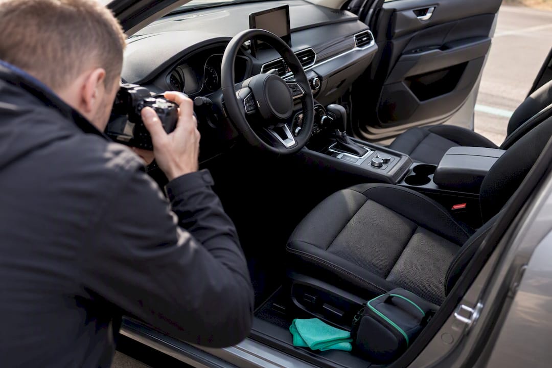 Photographer documenting vehicle interior condition