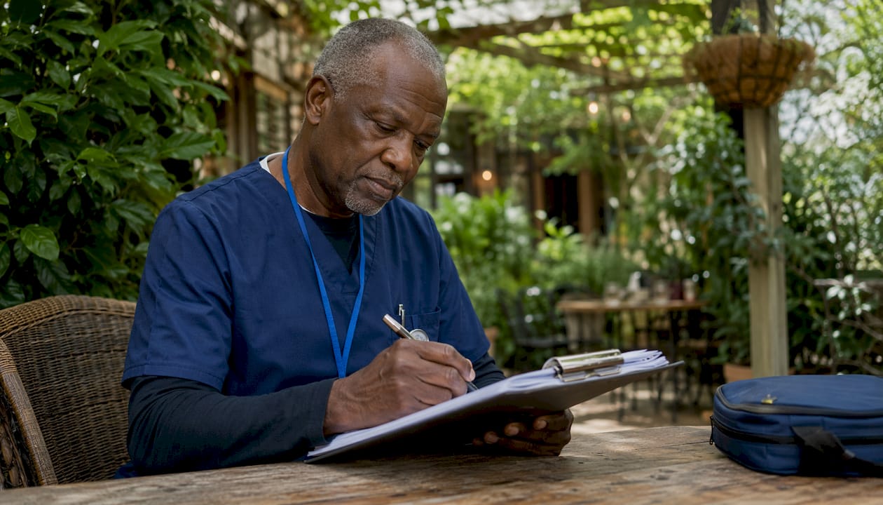 Nurse completing risk assessment documentation
