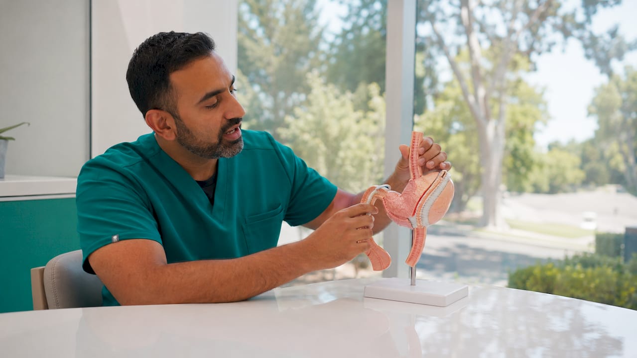 Surgeon demonstrating sleeve-to-bypass conversion with model