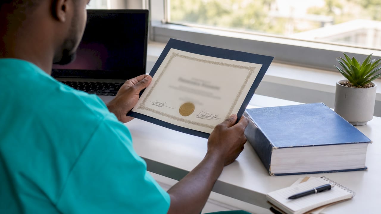 Surgeon's hands with credentials on desk