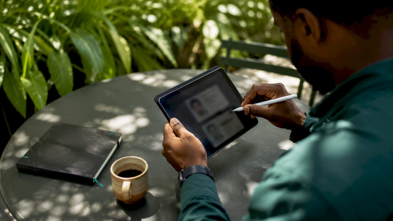 Man interacting with digital identity credential on tablet