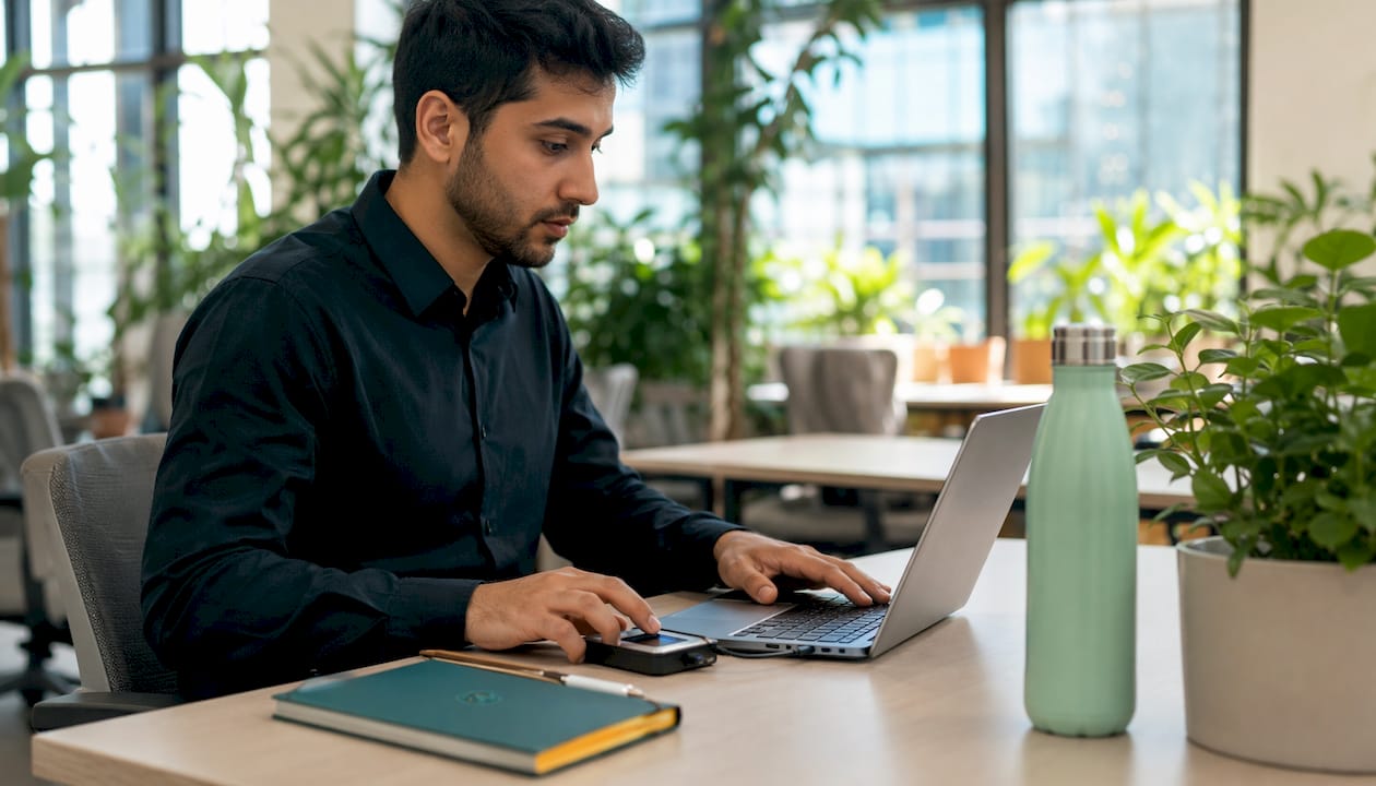 Hands typing biometric data in fintech office