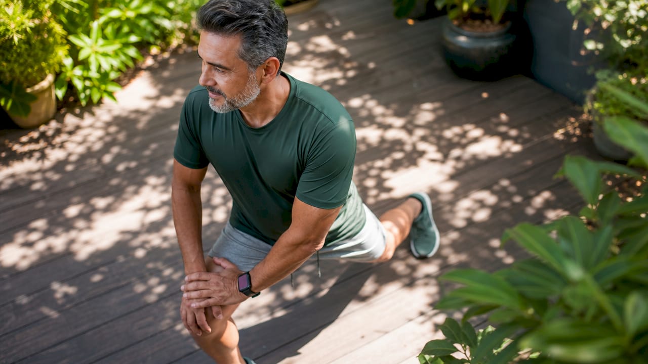 Man stretching in home gym wellness setup