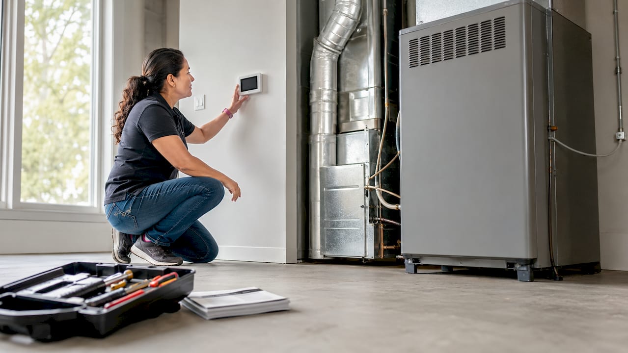 Woman checking new HVAC system in basement