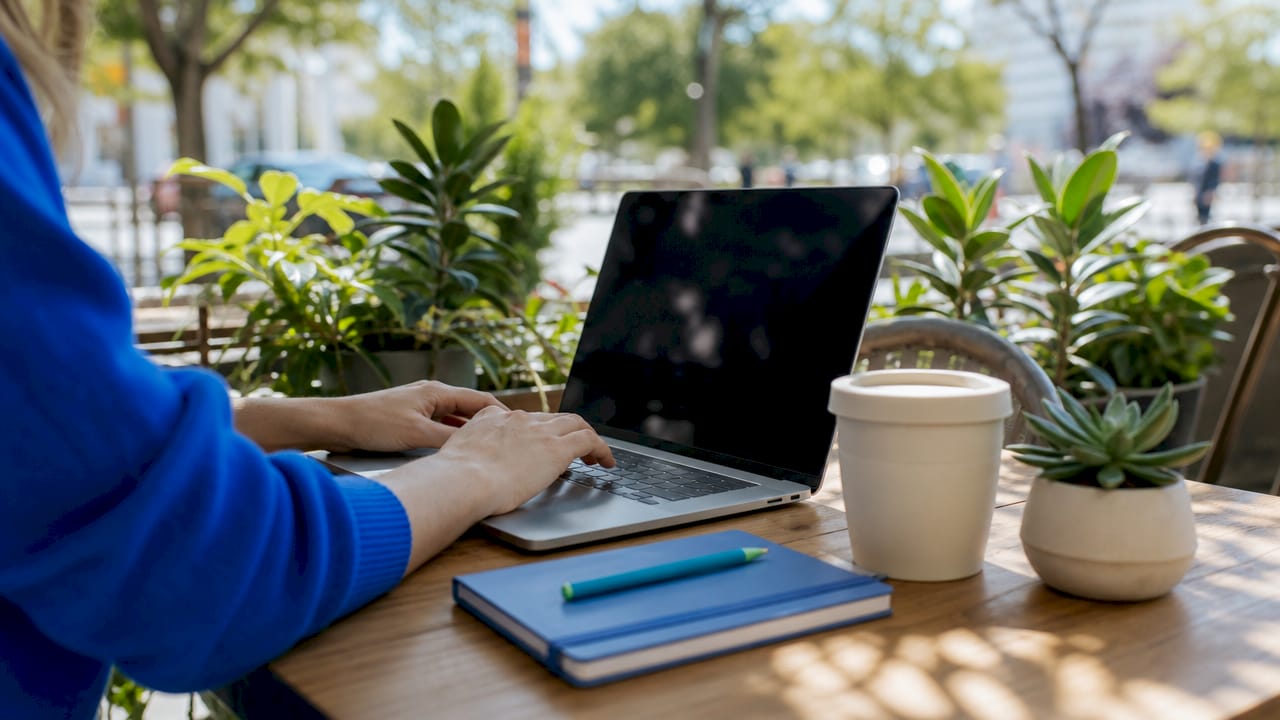 Hands typing on keyboard in corporate AI email setting