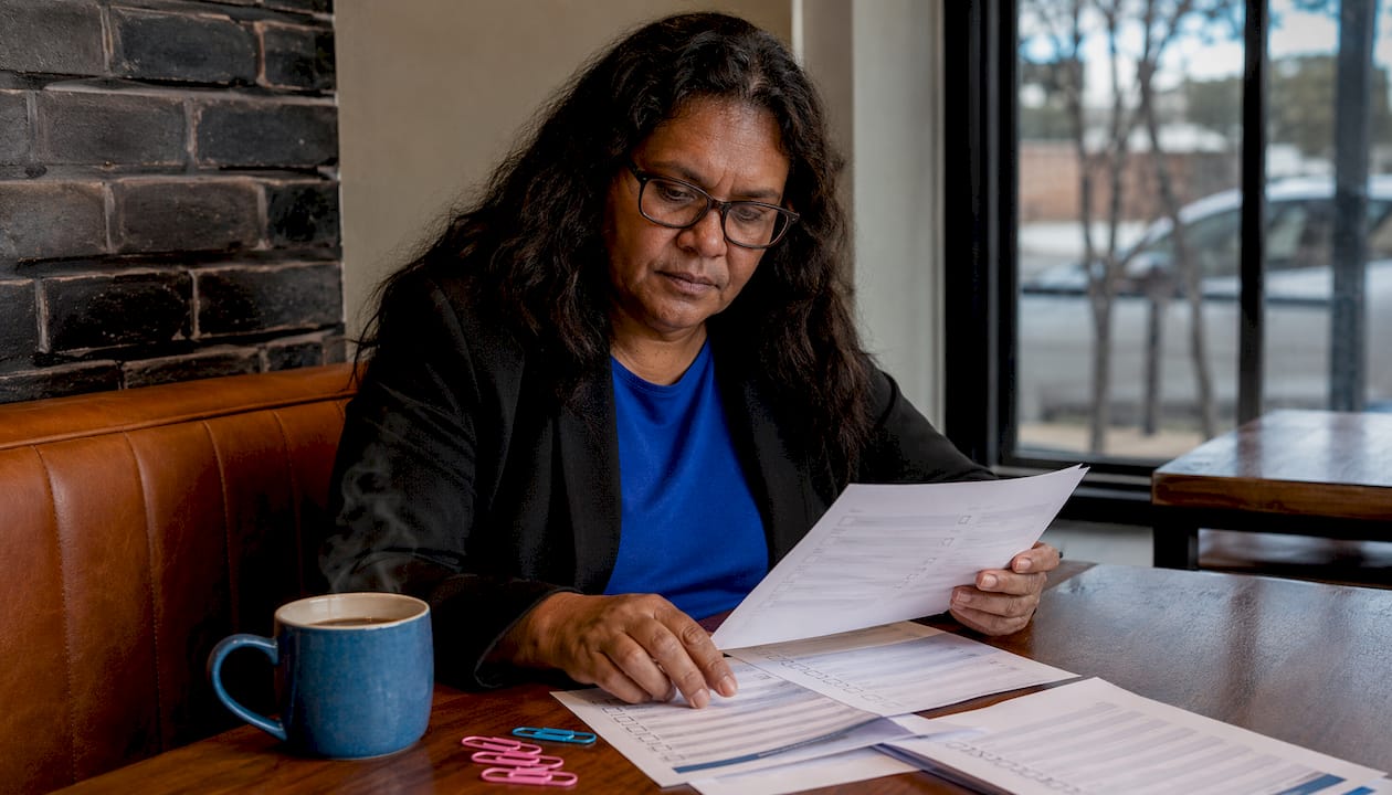 Woman reviewing security compliance documents