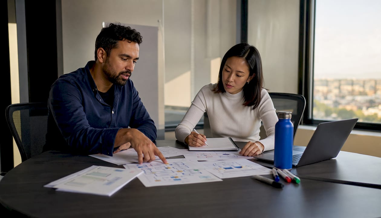 Two professionals discussing AI architecture