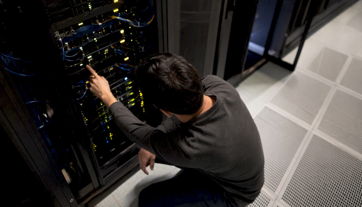 Hands inspecting server outage lights