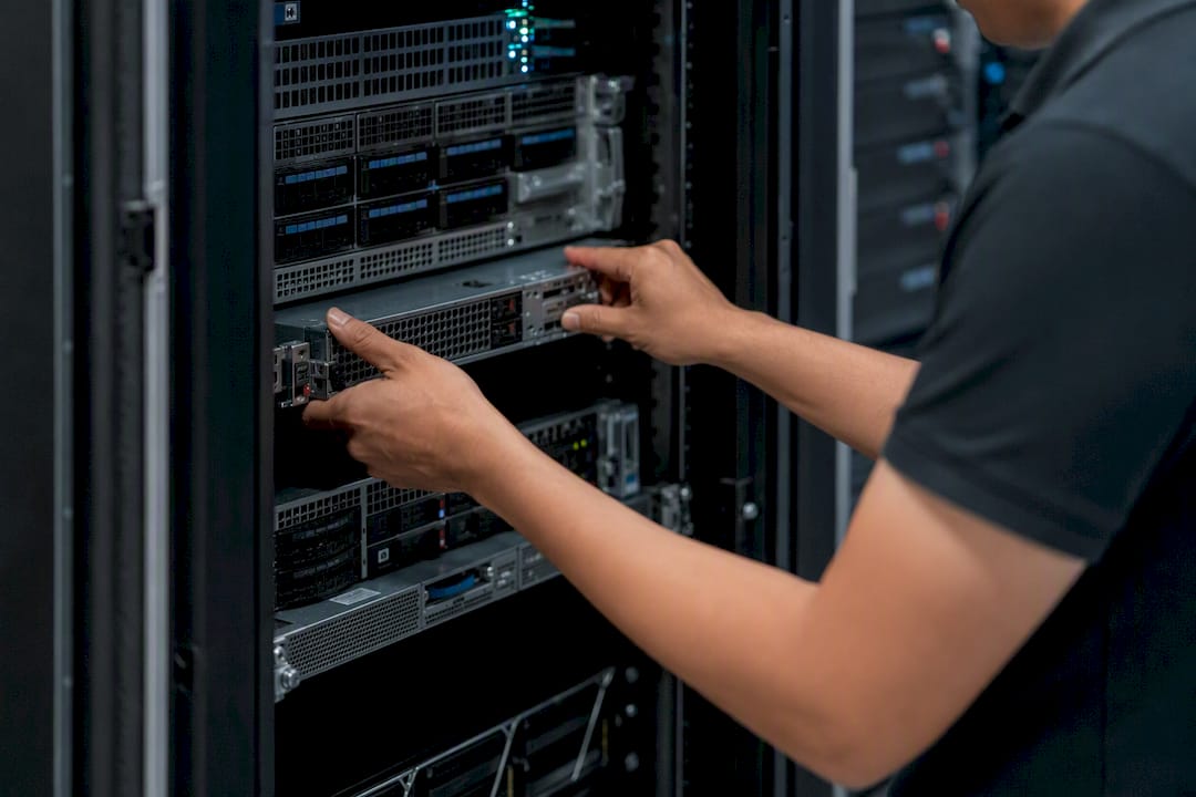 Hands installing security module in server room