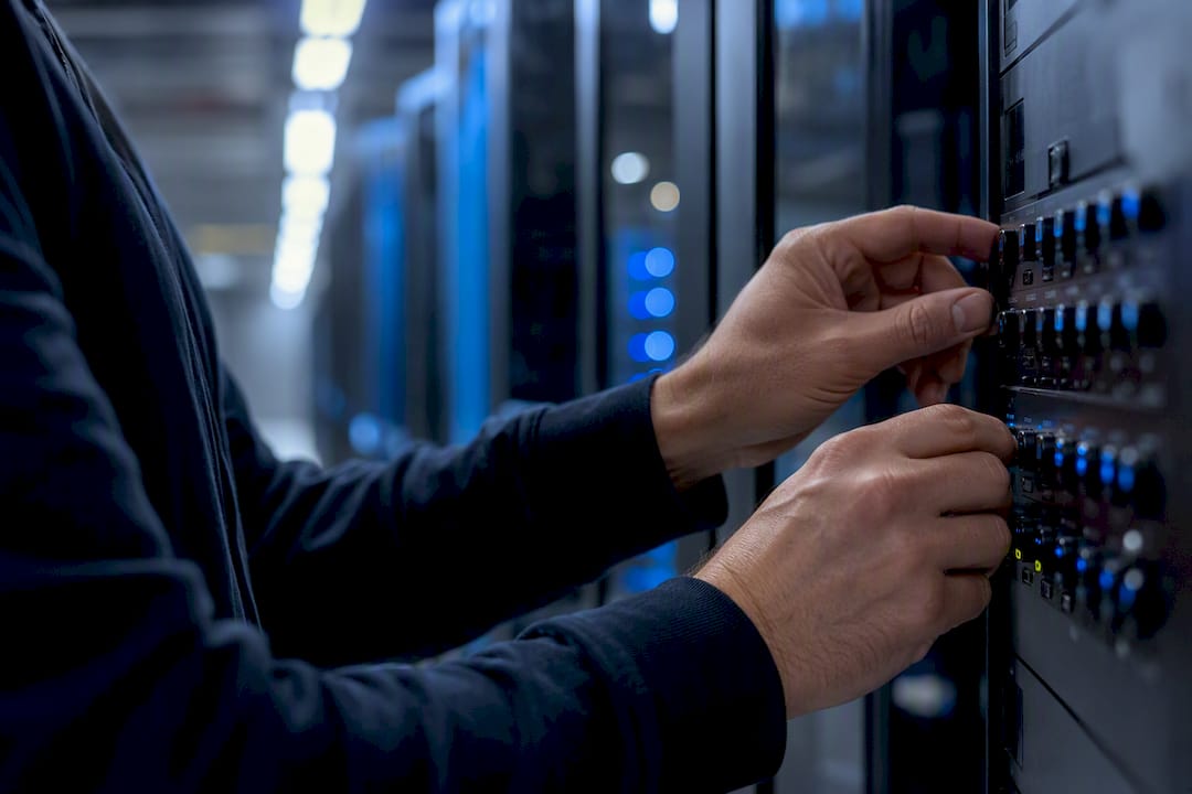 Hands adjusting server panel dials