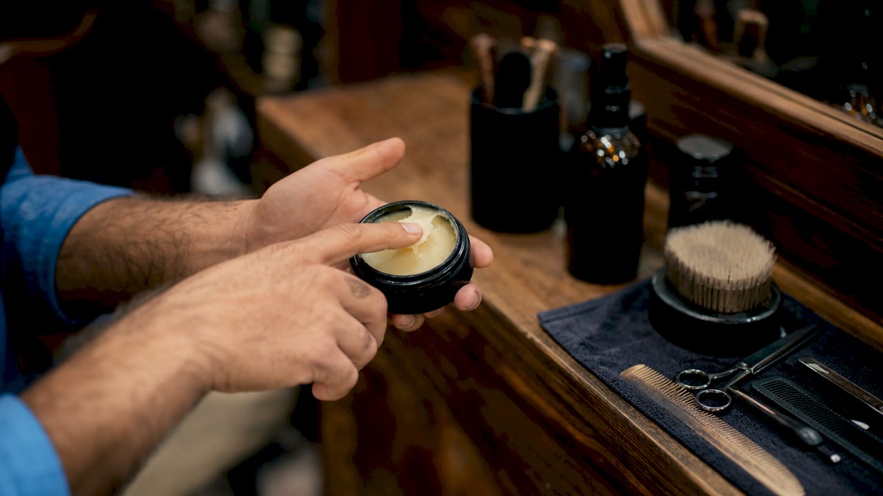 Close-up of hands holding professional grooming product