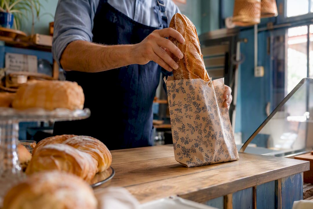Hands exchanging bread at a local bakery
