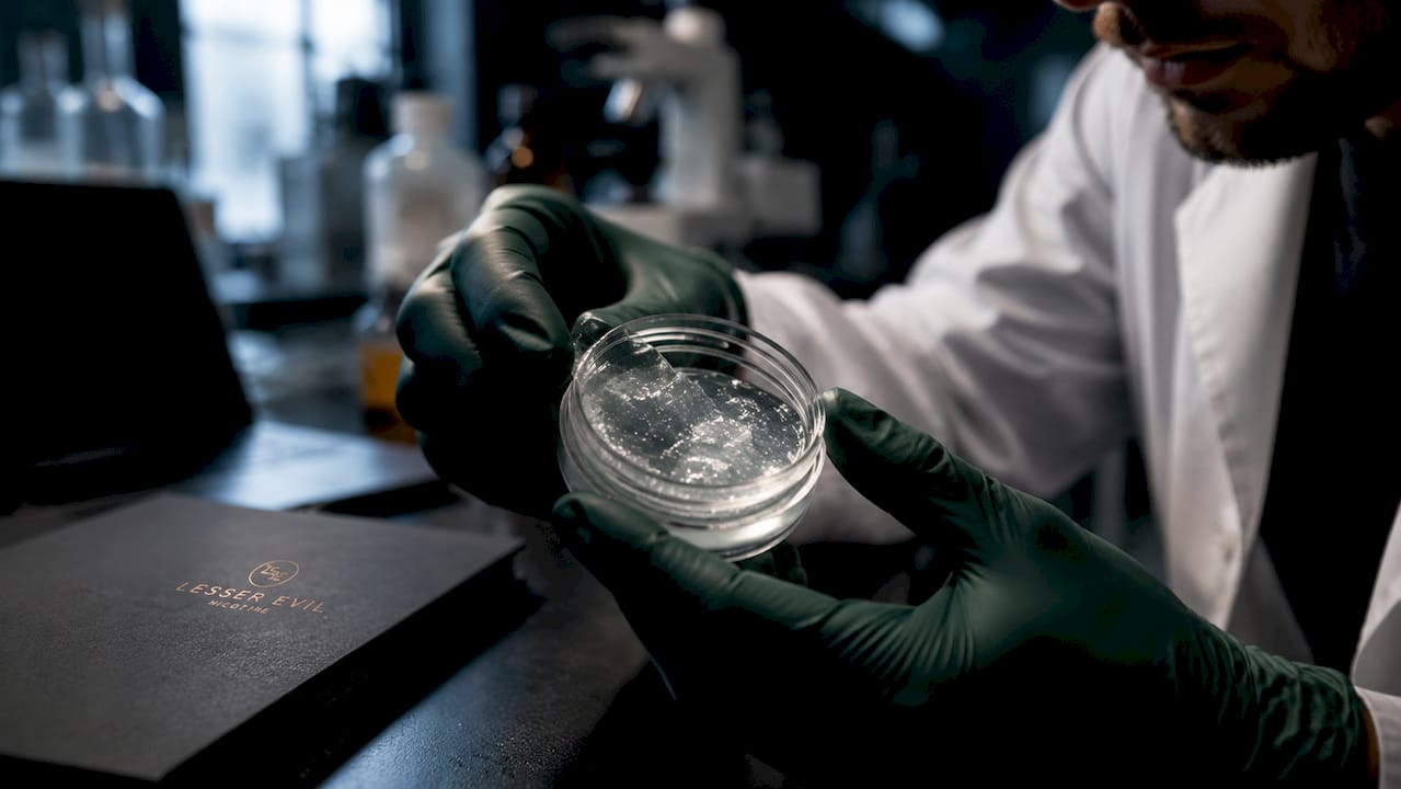 Hands holding nicotine nanogel container