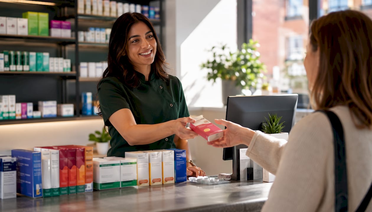 Pharmacist handing nicotine gum to customer