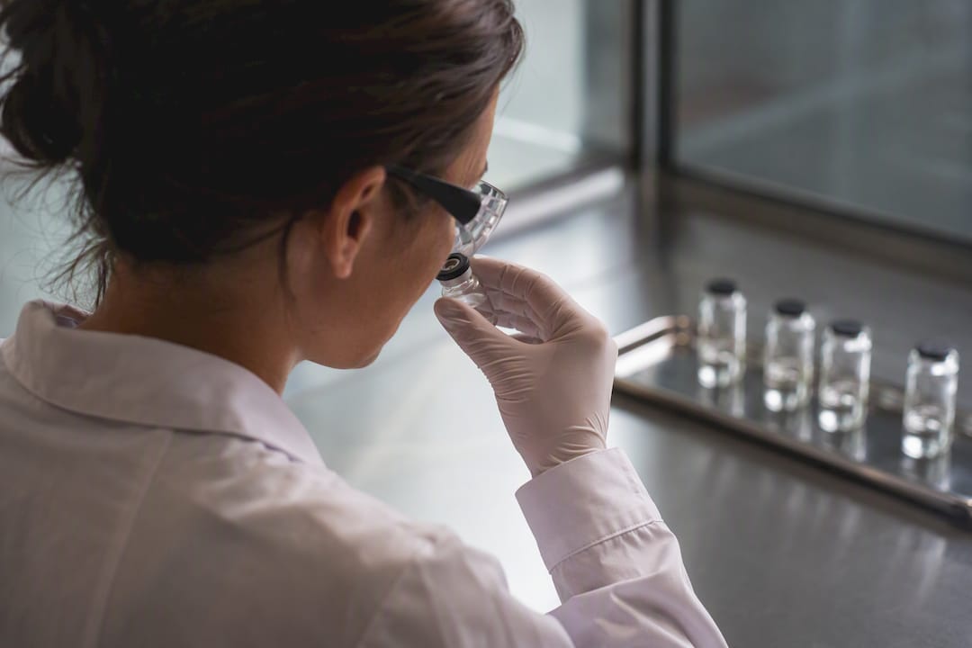 Technician evaluating sealed sample vial odour