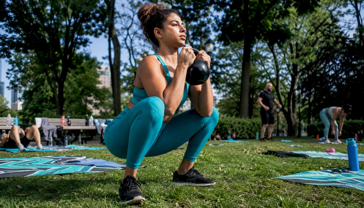 Woman doing goblet squat in gym