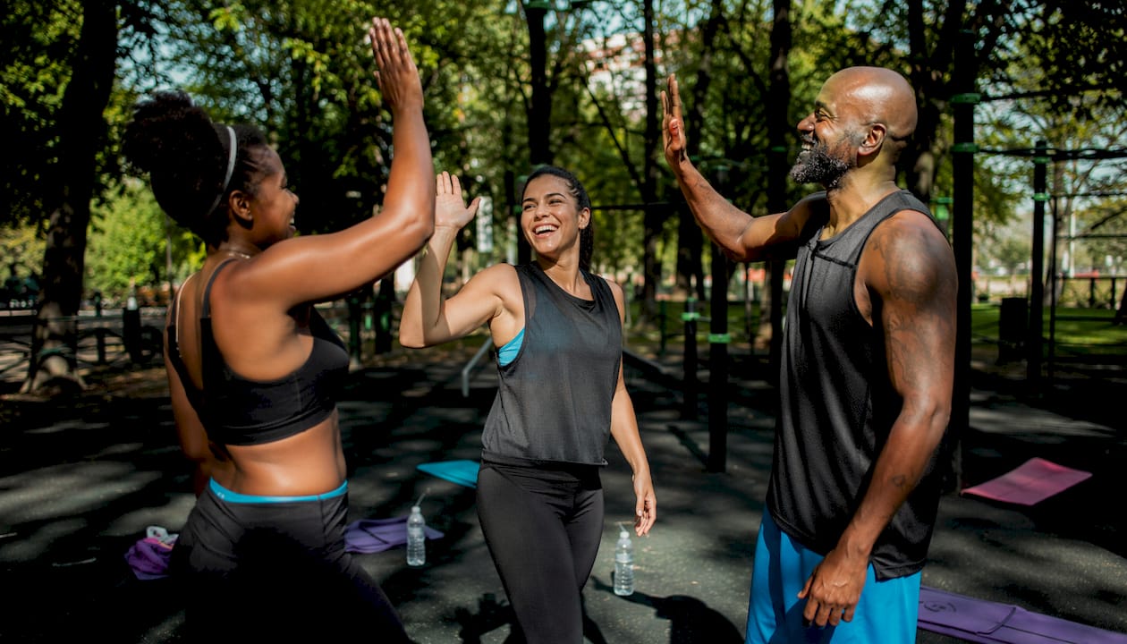 Diverse gym group chatting after class