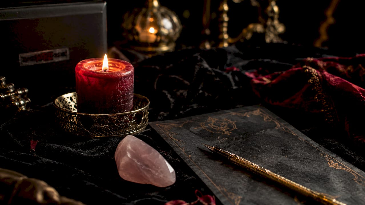 Close-up of love ritual materials candle rose quartz