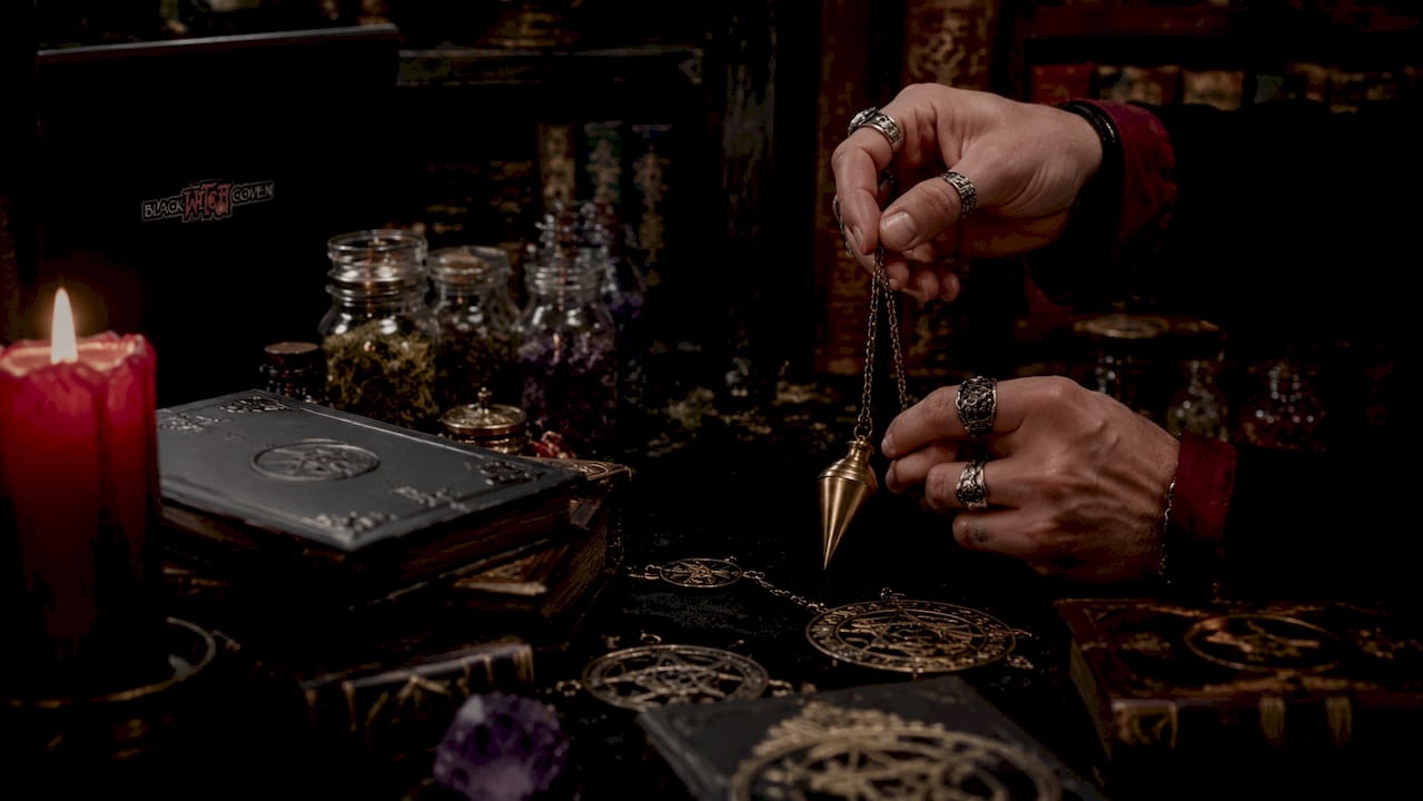 Close-up of hands with occult tools on altar