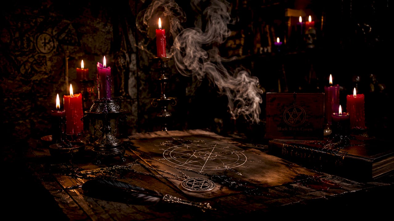 Close-up of ritual candles, sigils, and smoke on altar