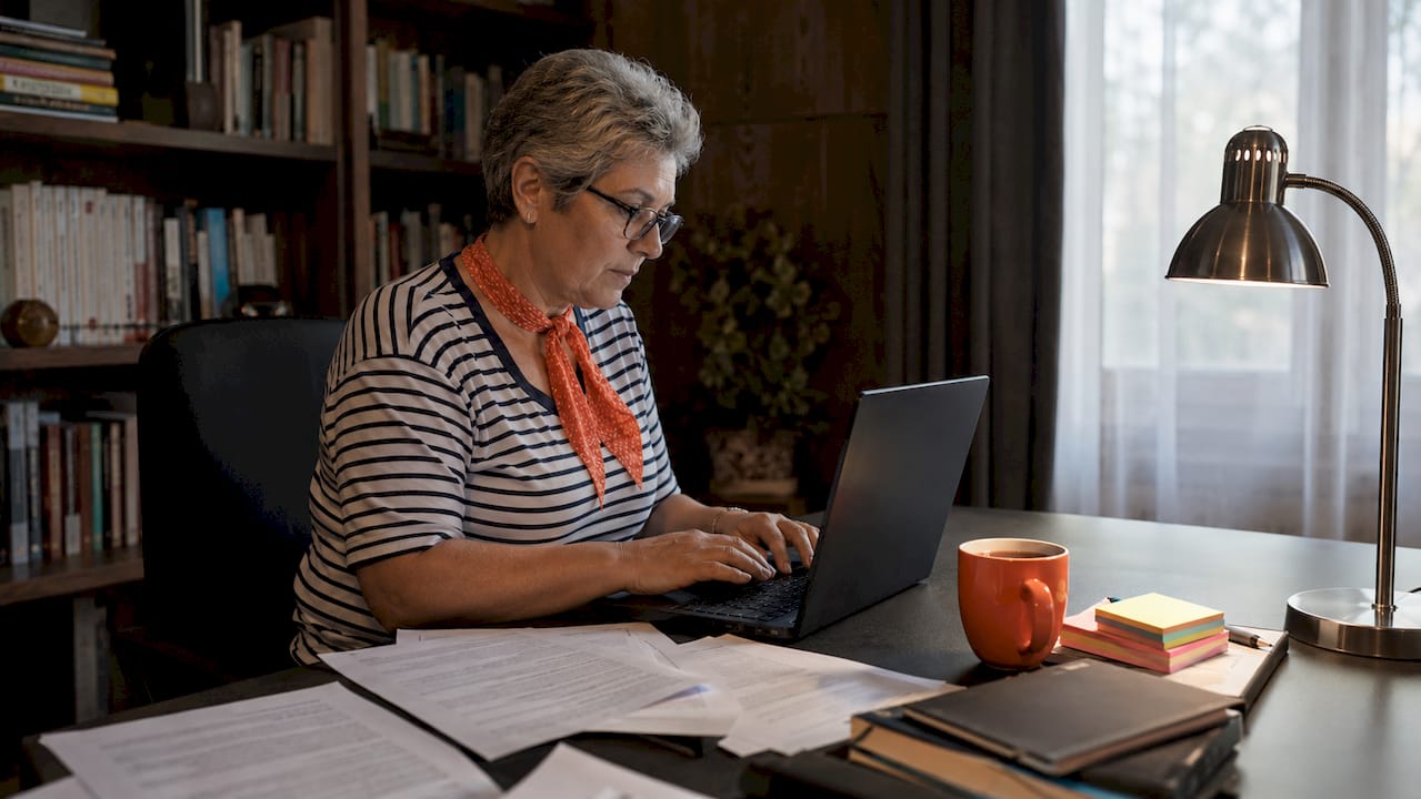 NAATI-certified translator working at desk