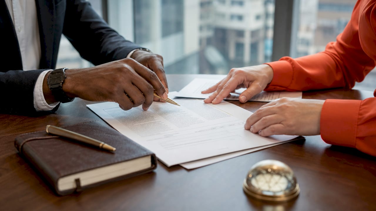 Close-up of hands handling certified legal documents