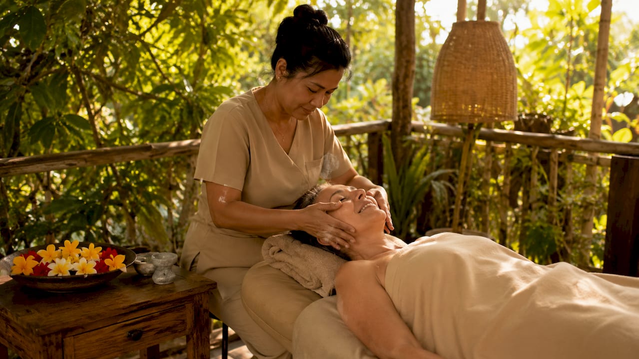 Hands performing therapeutic facial massage