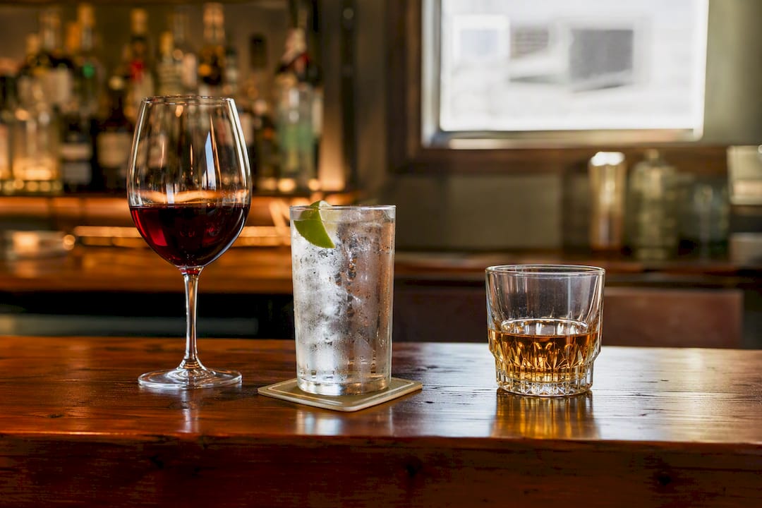 Variety of alcoholic drinks on wooden bar