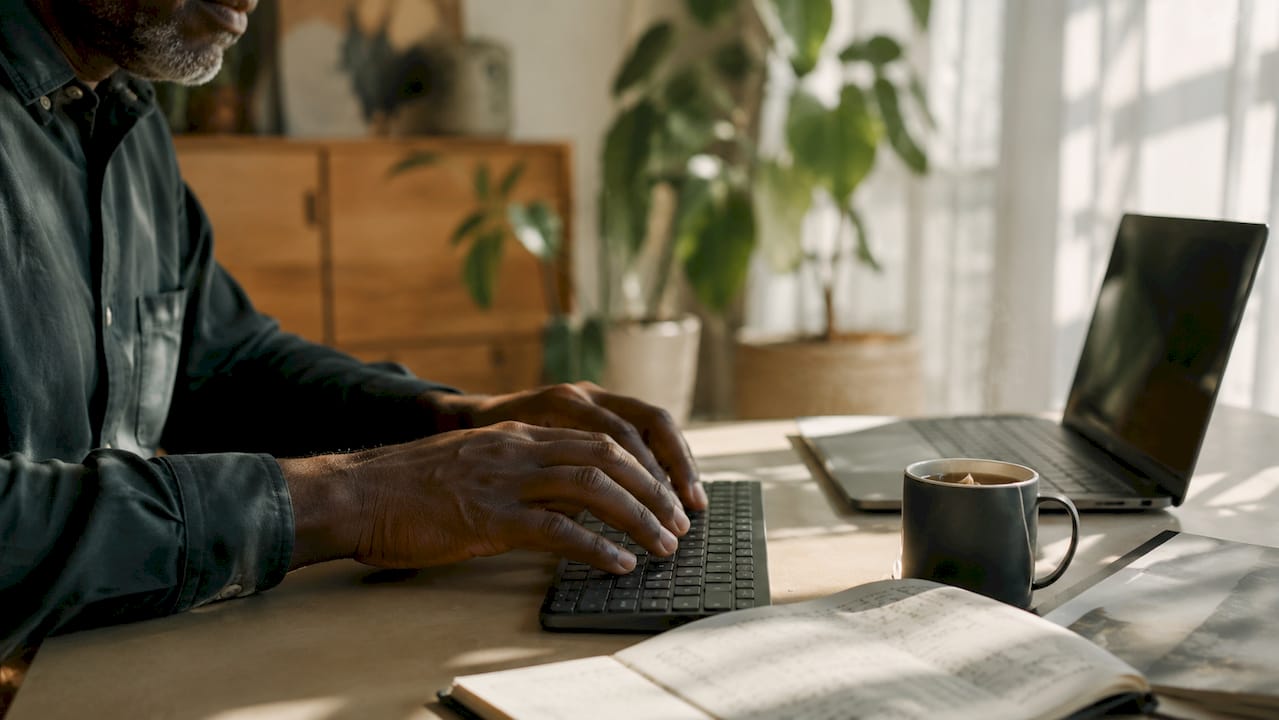 Hands typing marketing data on keyboard
