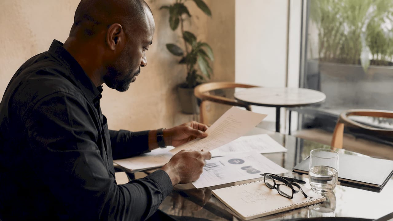 Overhead view of entrepreneur sorting strategy documents