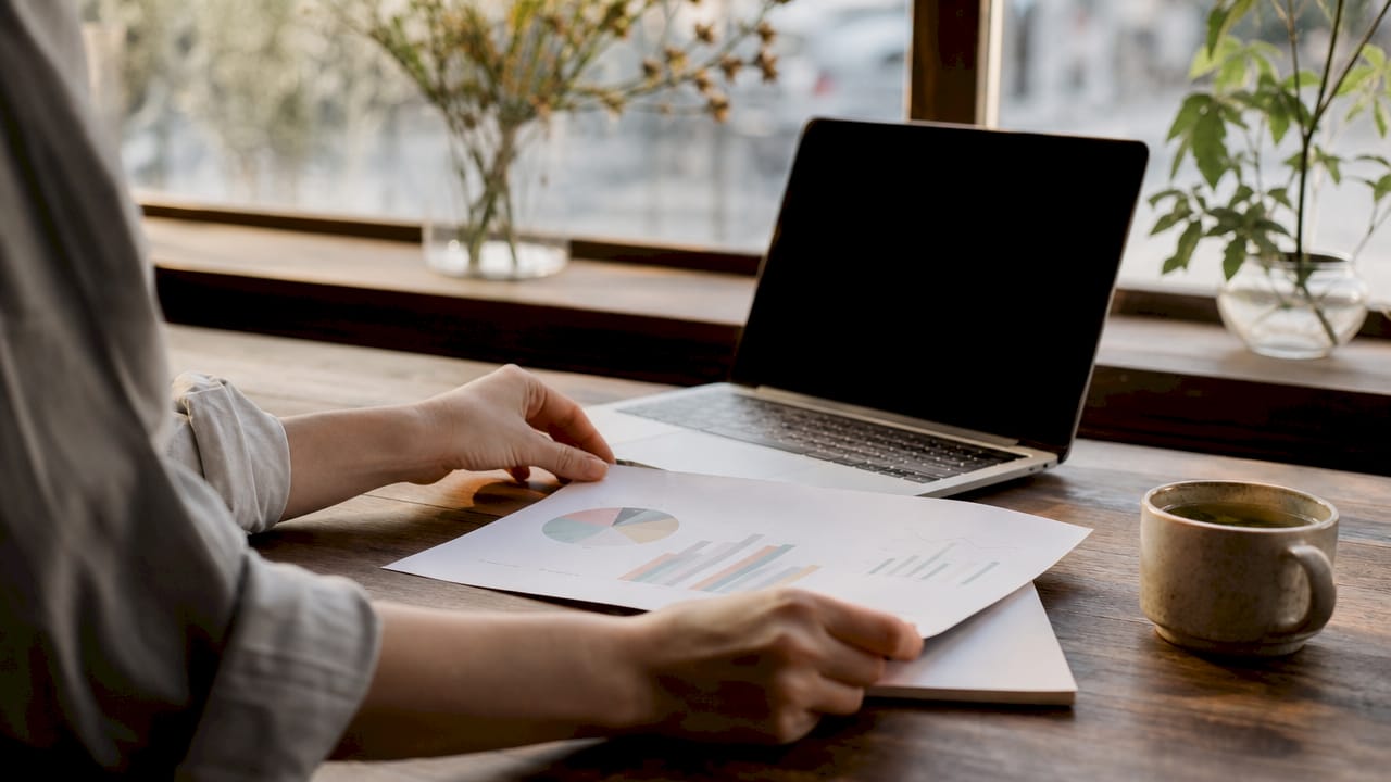 Hands typing on laptop with search audit report