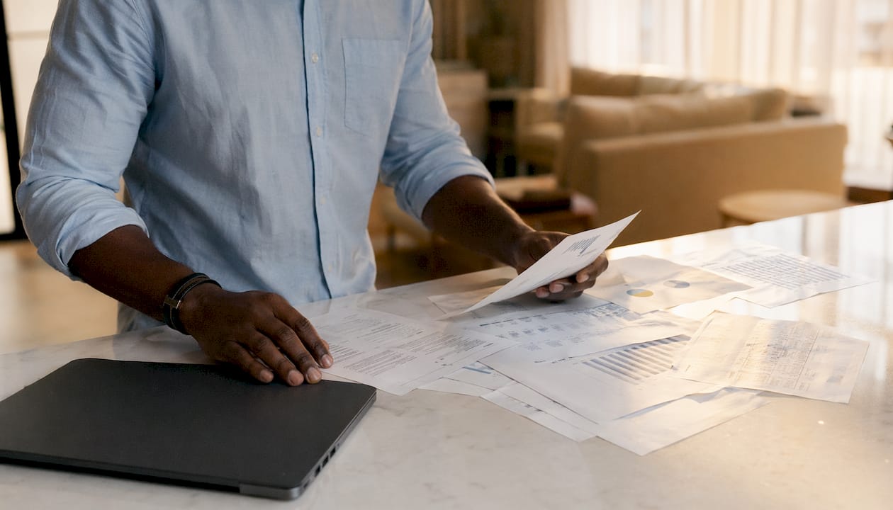 Hands sorting data sheets on desk